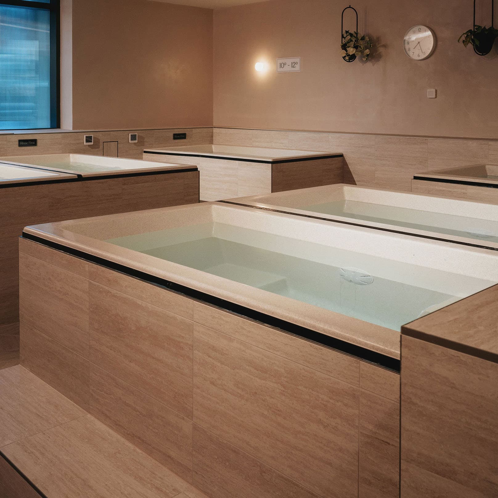 The ice bath room, with two baths side by side under warm lighting