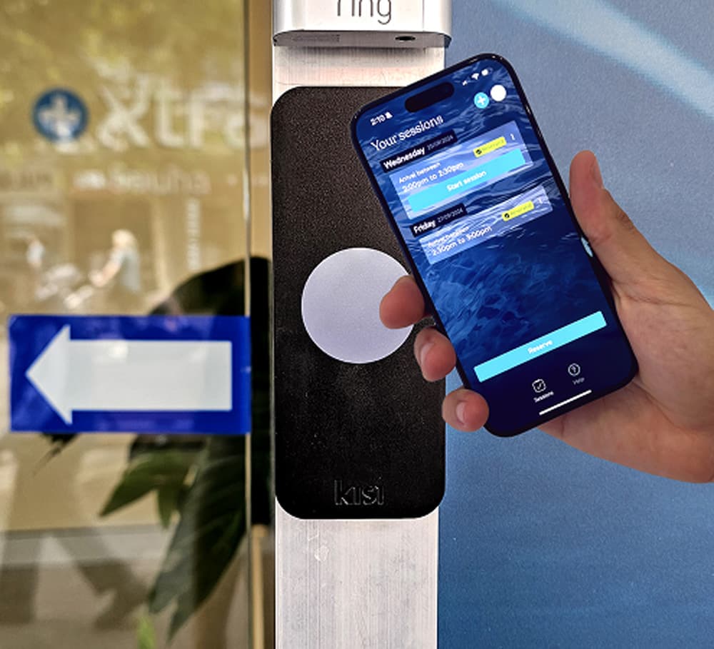 A phone held up to the reader beside the club door