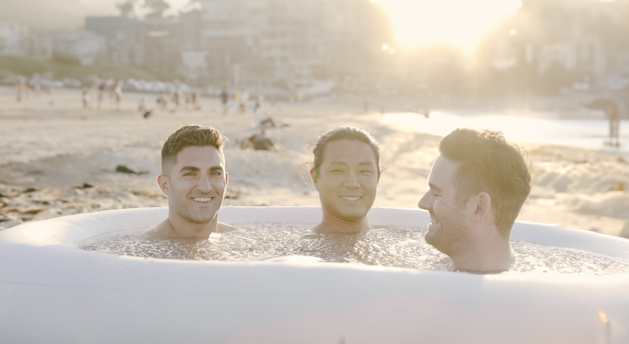 Men in Group Cold Therapy Session on beach